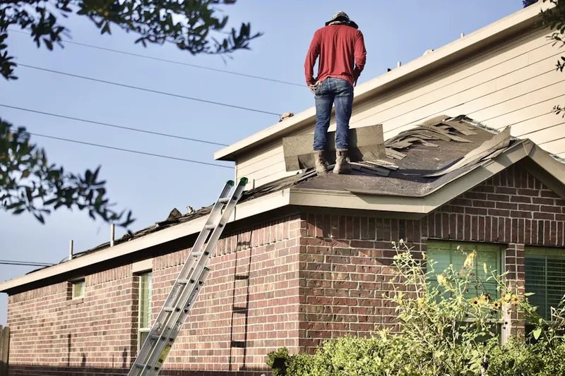 Professional roofer working on a residential roof in Florida Center